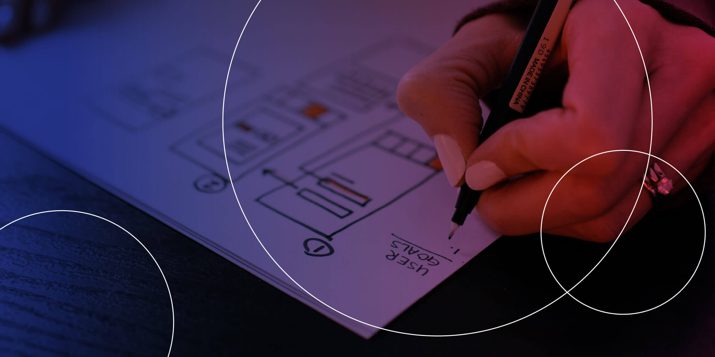UX design student writing down some user goals.