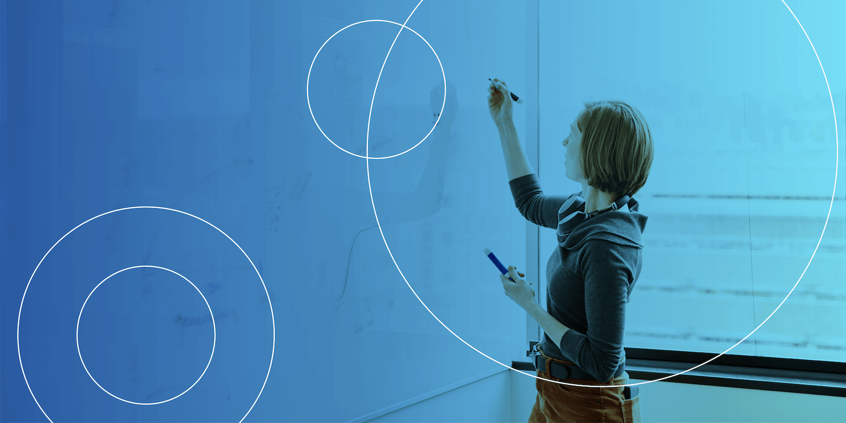 Woman about to draw on a whiteboard.