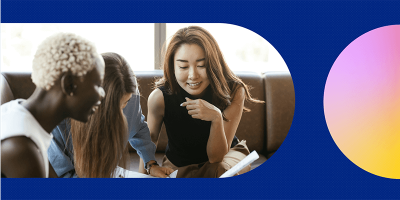 A group of smiling female coworkers having a planning session.