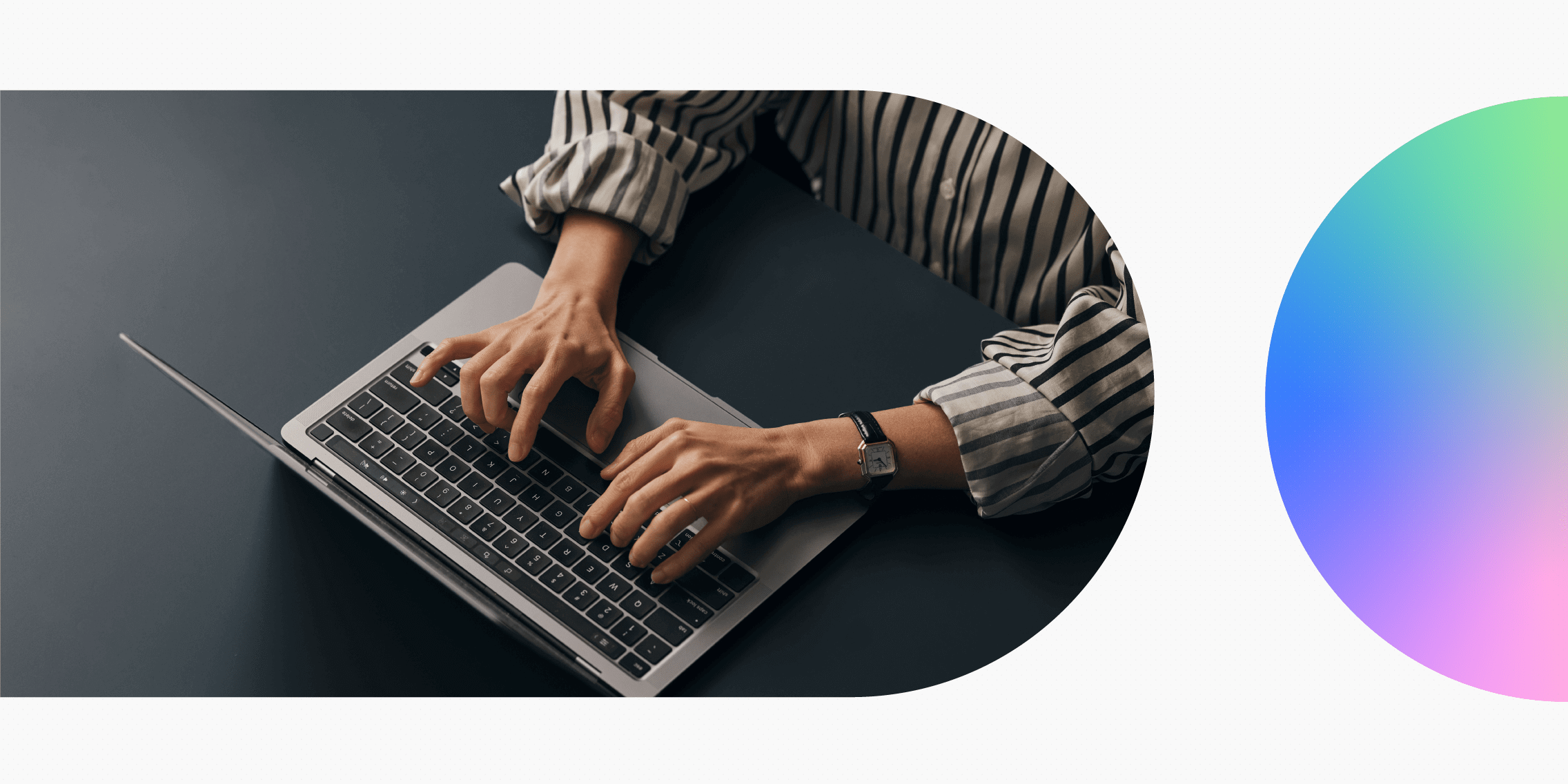 Top view of a person typing on a laptop.