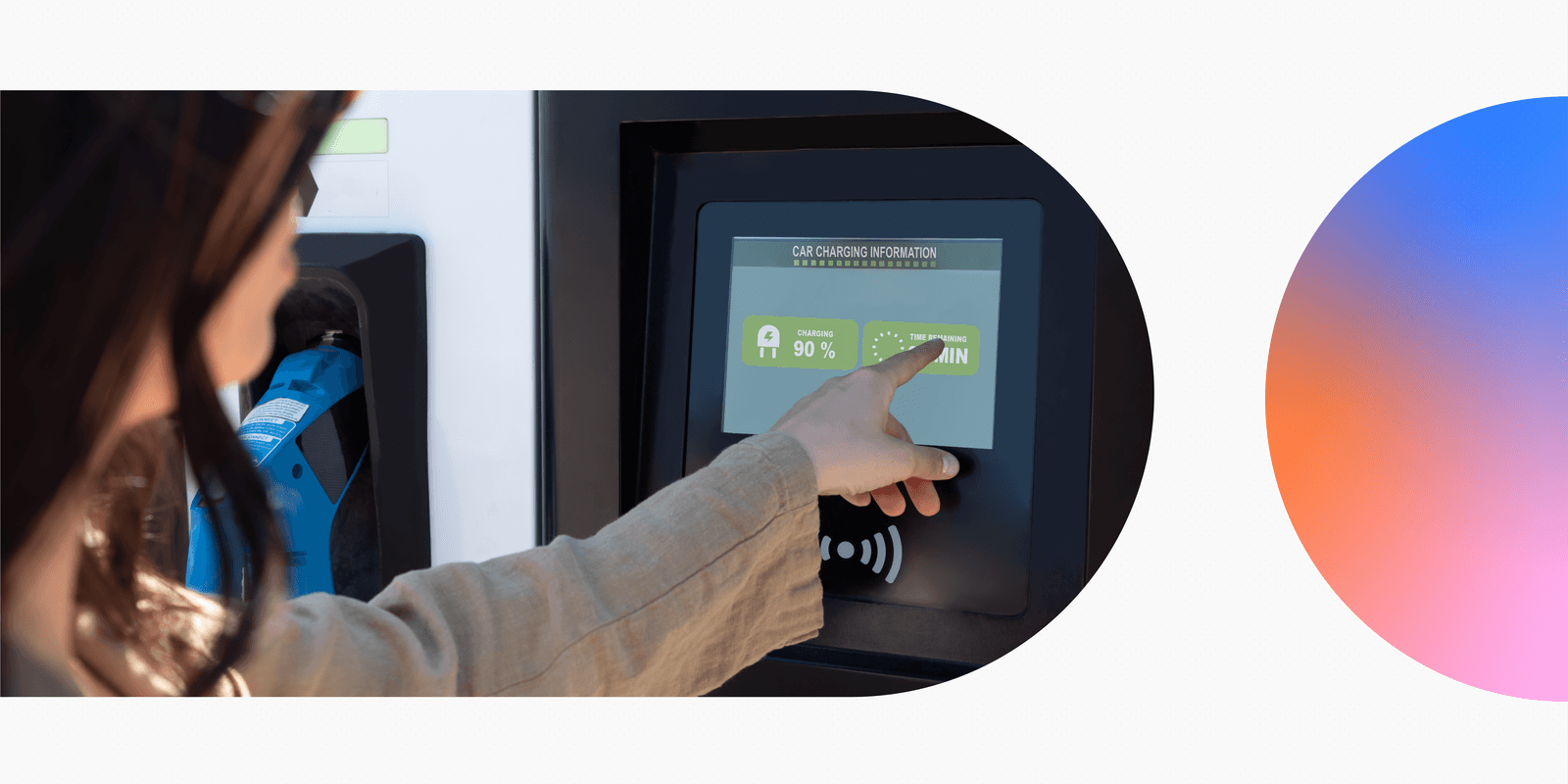 A woman pointing at a car charging information screen.
